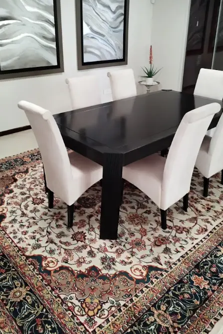 Traditional dining set over Persian rug