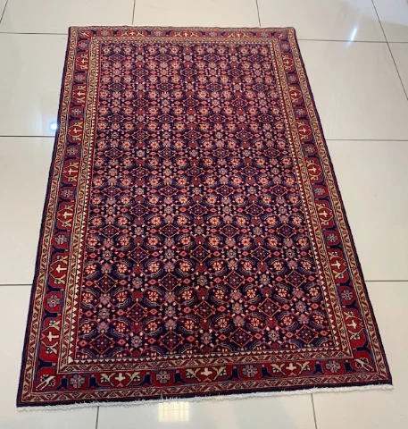 Crimson rug with repeating octagon medallions