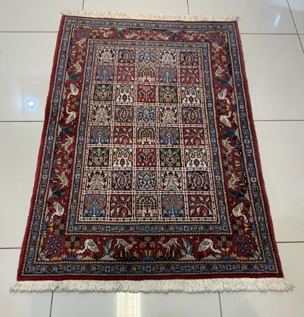 Burgundy Bokhara rug with rows of oval guls