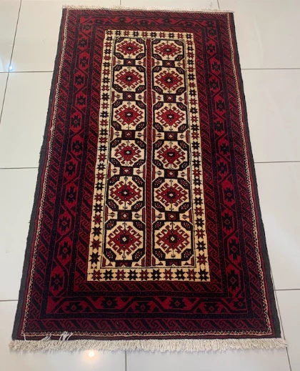 Sand tan Baluch rug with central star medallion