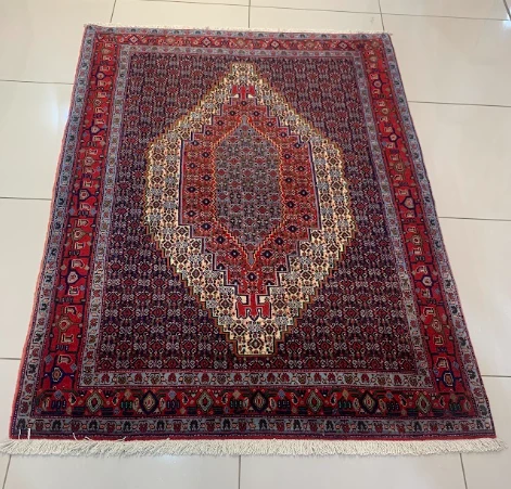 Oxblood Turkoman rug with diamond medallion grid
