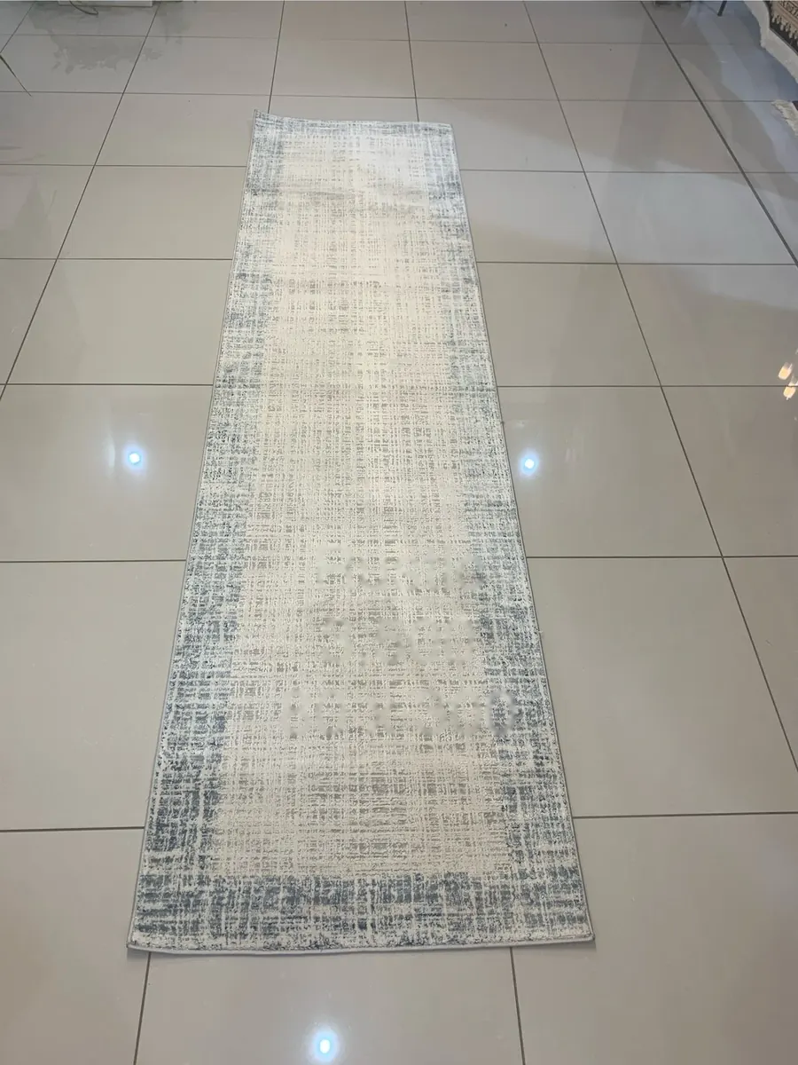 Rustic machine-made runner rug with ivory and blue distressed pattern