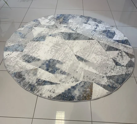 Round geometric rug in blue, grey and cream