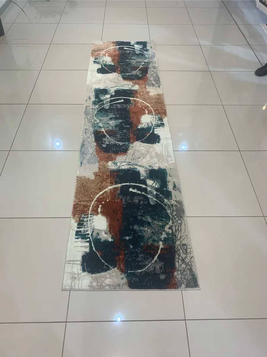 Urban machine-made runner rug with rust and teal circle pattern