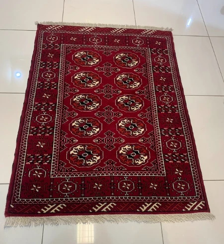 Garnet red Baluch rug with diamond lattice and tribal border