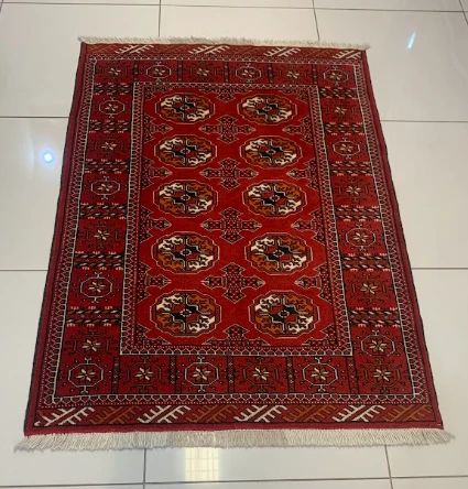 Vermilion Bokhara rug with grid of octagon medallions