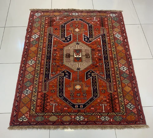 Rouge red Qashqai rug with diamond medallion and animal motifs
